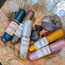 Set of skincare products on a decorative plate with crystals