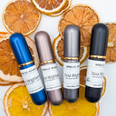 Four bottles of Wildroot Alchemy products on a white background with dried oranges.