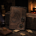 Decorative leather-bound book with embossed design on a rustic wooden table with a fireplace in the background.