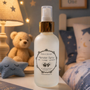Monster spray bottle on a nightstand with teddy bear and decorative items in the background
