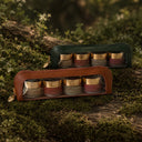 two sets of four body scrubs and polishes in faux-leather cosmetic pouches