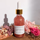 Bottle of 'Love Potion No. 13' on a wooden surface with flowers