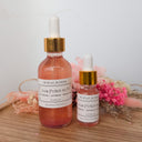 Two bottles of 'Love Potion no. 13' with gold caps on a wooden surface.